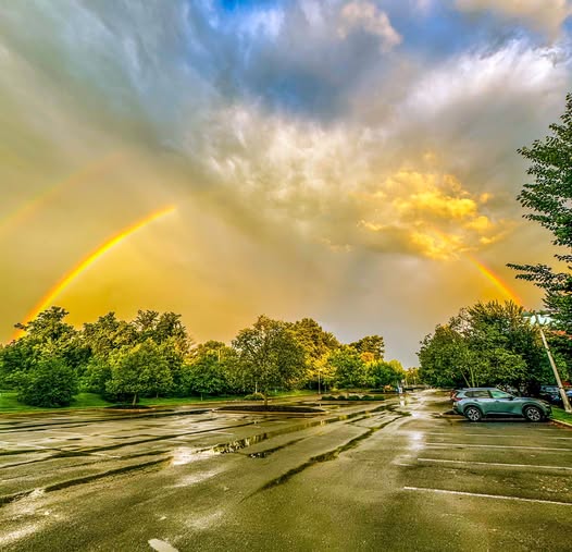 Double rainbow over a rain-soaked parking lot after a thunderstorm in Norristown